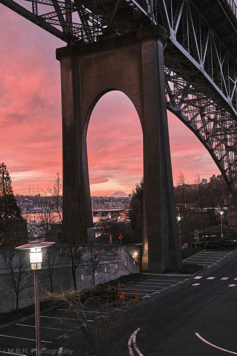 Mt Rainier with pink sunrise clouds seen under the Aurora Avenue Bridge Mt Rainier with pink sunrise clouds seen under the Aurora Avenue Bridge